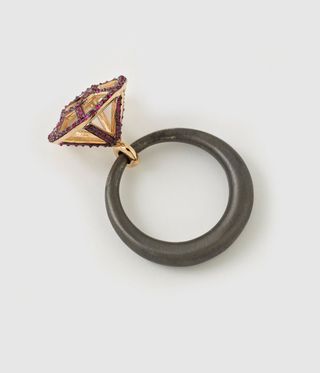 A cage of rubies on a black ring