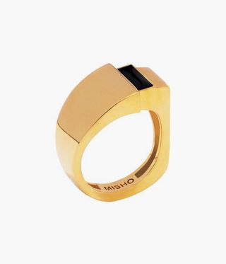 gold ring with a black bar on it