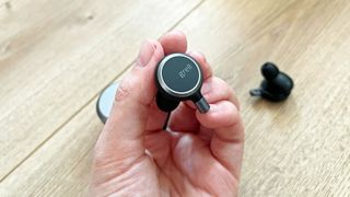 Grell Audio TWS/1 earbud in a hand