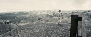 A screengrab from the final "Interstellar" trailer showing Cooper and a strange robot exploring an alien world.