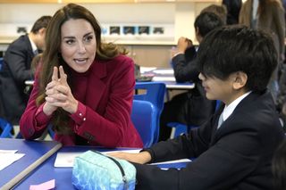 Catherine, Duchess of Cambridge speaks to students during a visit to Nower Hill High School on November 24, 2021