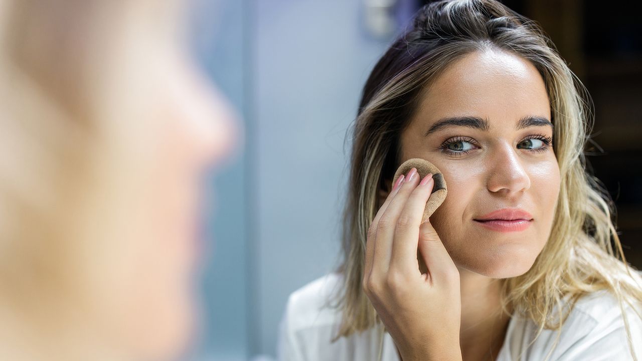 woman applying make-up with sponge