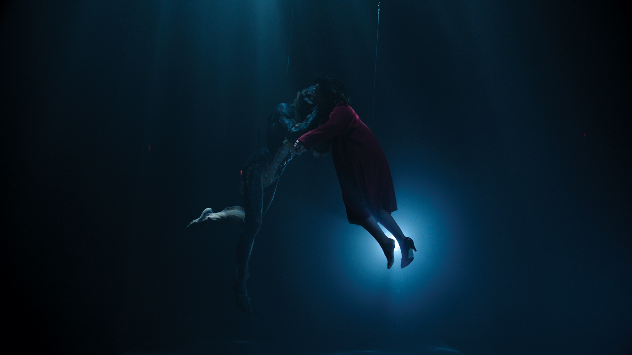 A dry-for-wet plate where Doug Jones and Sally Hawkins are suspended by wires as projectors hanging from the ceiling create the impression of caustic light beams