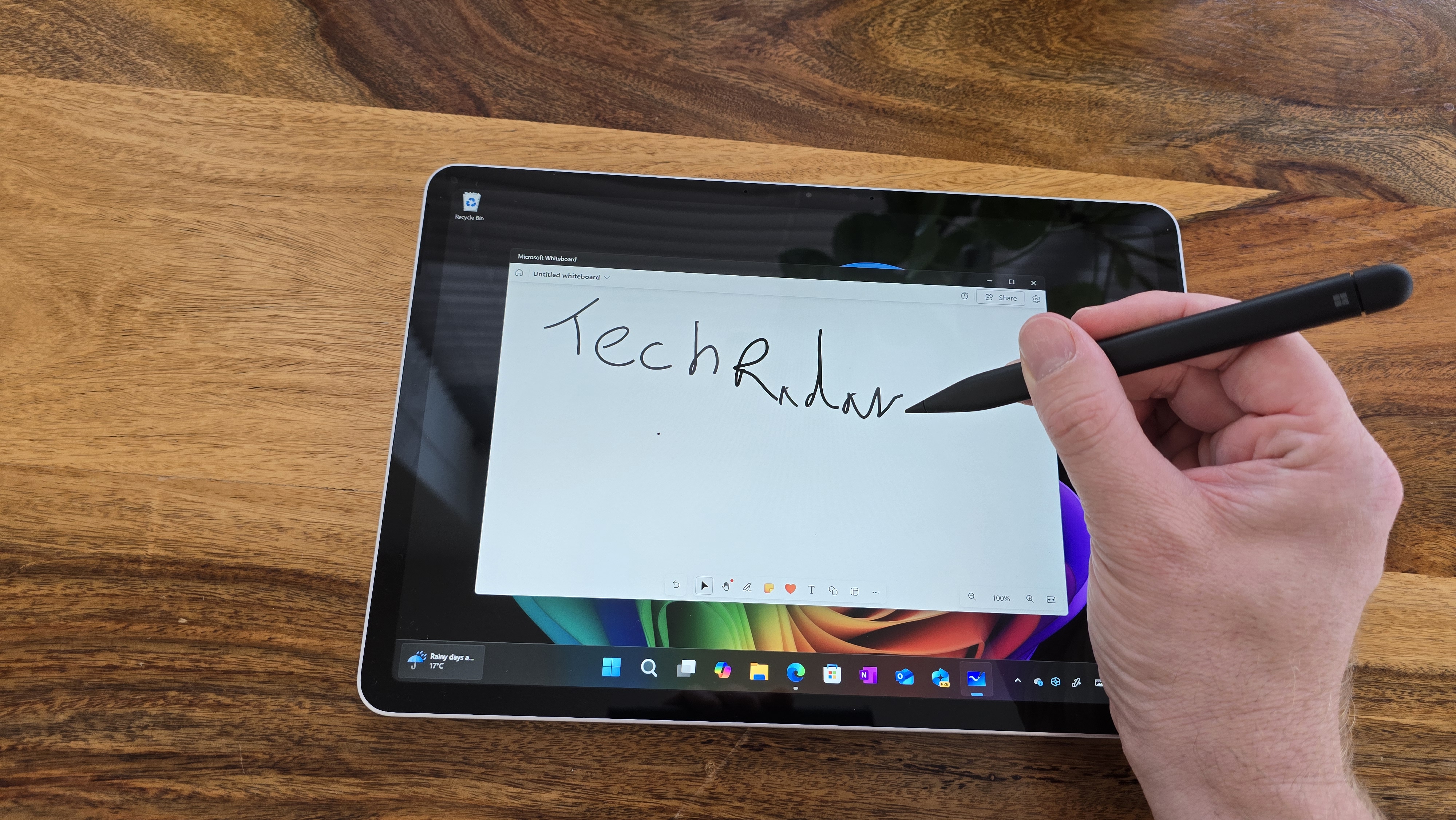 Microsoft Surface Pro 12 tablet on wooden table in relaxed cafe