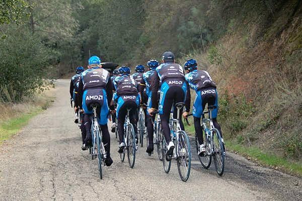 Riders get out of the saddle as the climb steepens.