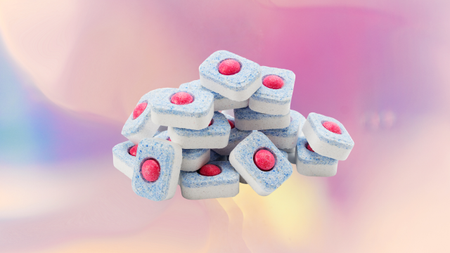 Dishwasher tablets on a pastel background