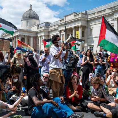Pro-Palestinians chant to the crowds in Trafalgar Square on June 23, 2025 in London, England. Members of the Palestine Action (PA) campaign group called an emergency demonstration as Home Secretary Yvette Cooper proscribed the group, making it unlawful to join the organisation.