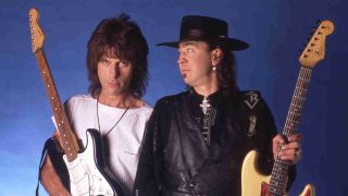 Jeff Beck and Stevie Ray Vaughan holding guitars while posing for a photograph