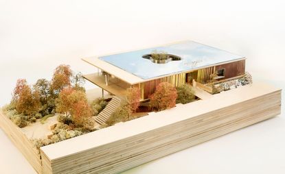 A digital image of Maggie’s Centre on horizontally designed oak wood platform with trees captured against a white background. 