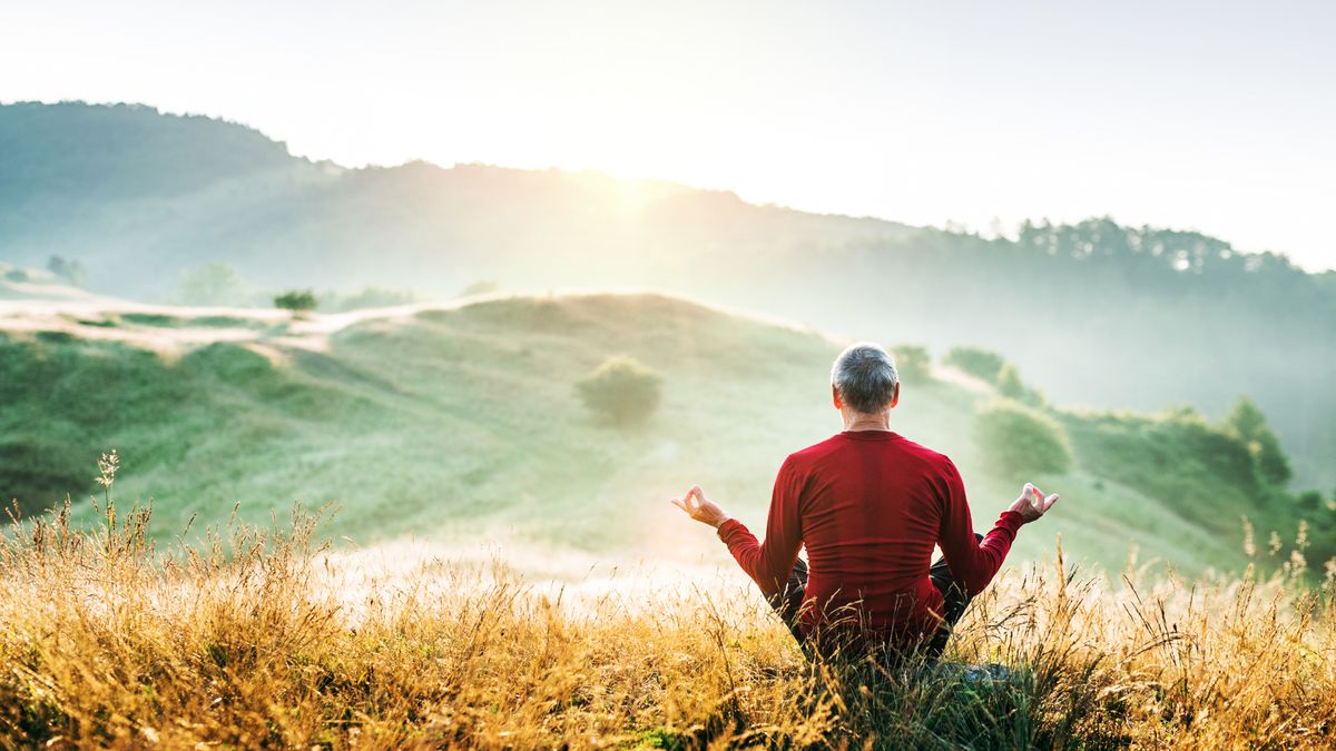 A man meditating in the countryside