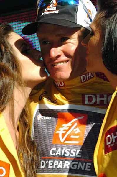 A happy Russian is treated to some nice kissing on the podium.