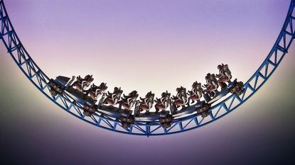 Low-angle view of a roller coaster dip