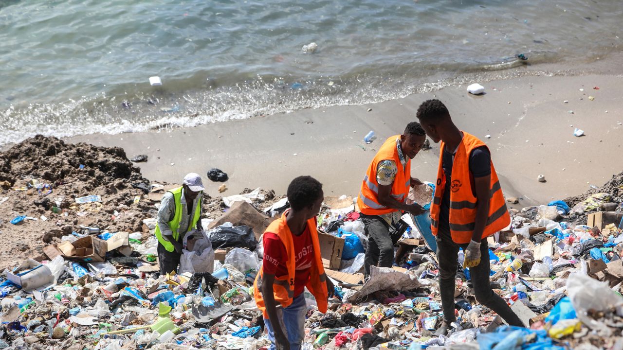 Men pick up plastic waste in Somalia