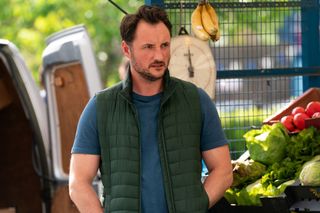 EastEnders Martin Fowler standing in front of his fruit and veg stall