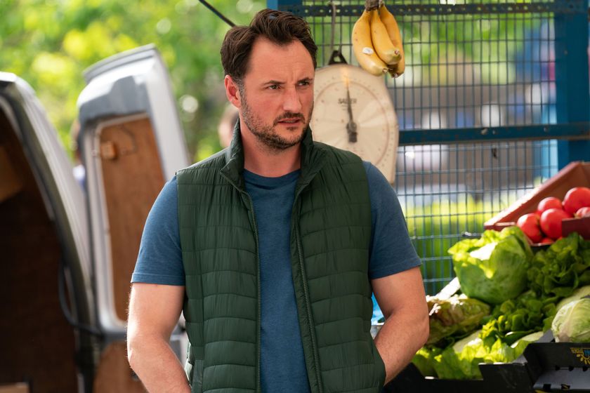 EastEnders Martin Fowler standing in front of his fruit and veg stall