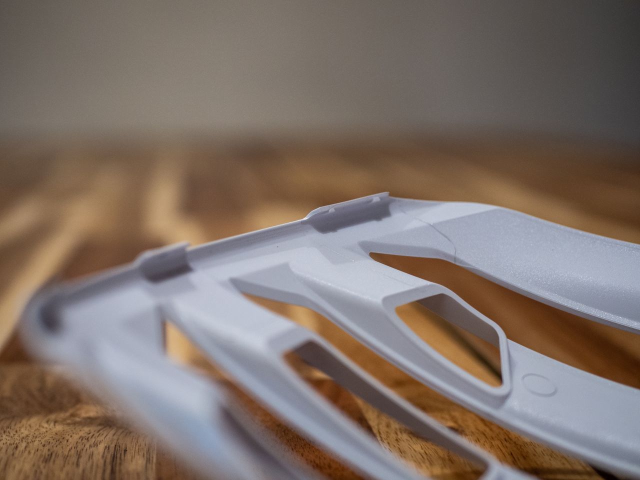 A white Uvex Surge helmet stands on a wooden table