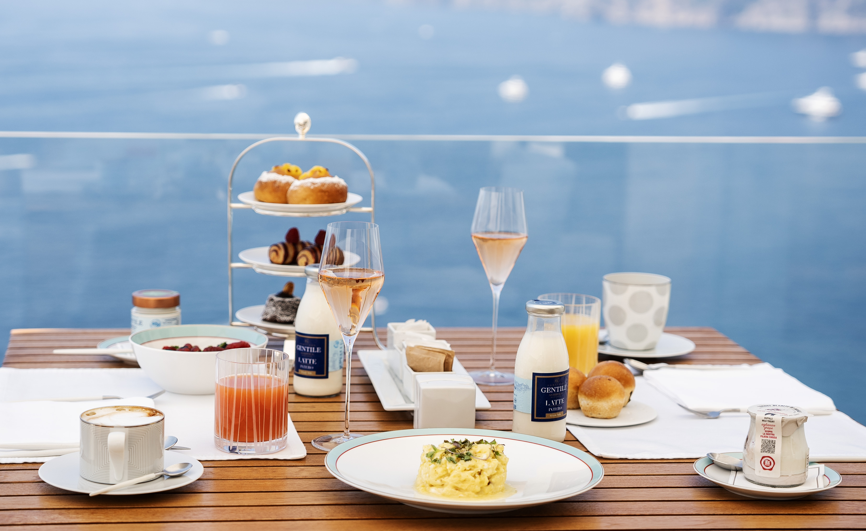 Breakfast plates on a table on a terrace at Casa Angelina