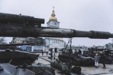 Visitors browse an exhibit of destroyed Russian military equipment and vehicles outside St. Michael's Golden-Domed Monastery in Kyiv, Ukraine