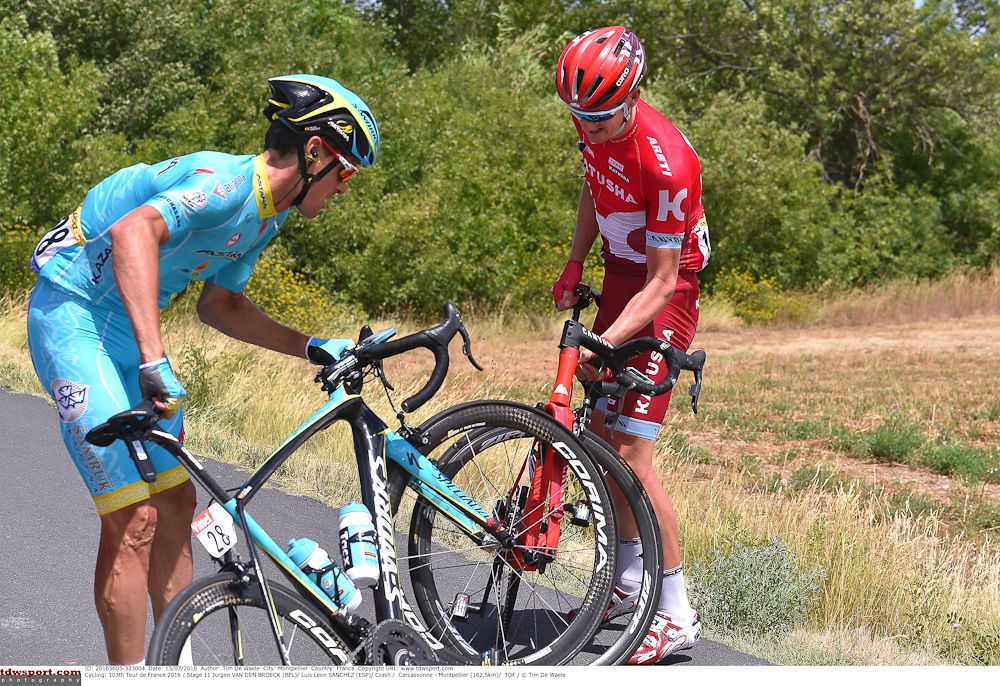 Jurgen Van den Broeck and Luis Leon Sanchez recover from a crash during stage 11 at the Tour de France.