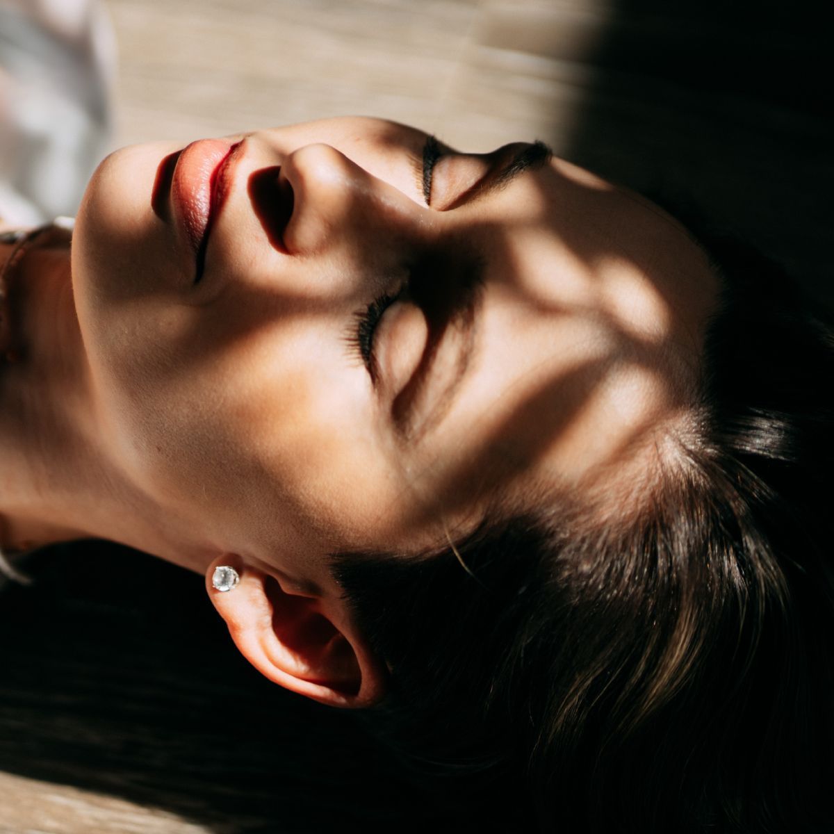 a close up of a woman&#039;s face with her eyes closed