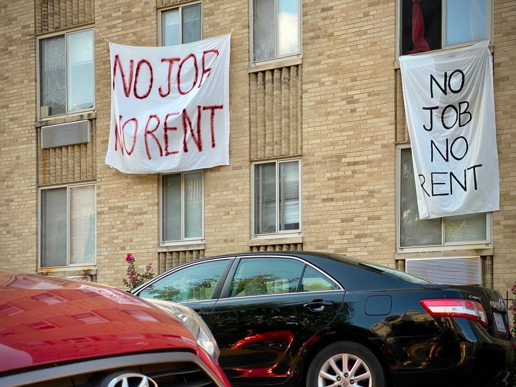 Protest signs calling for coronavirus relief measures.