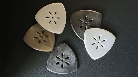 Techpicks guitar picks on a black background