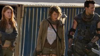 Ali Larter, Milla Jovovich, and Oded Fehr stand together looking grim in Resident Evil: Extinction.