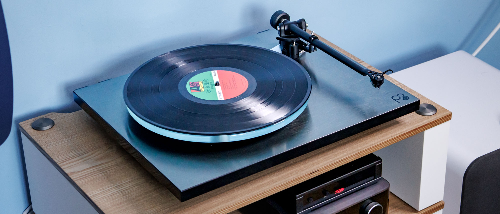 The Rega Planar 3 RS on an entertainment stand.