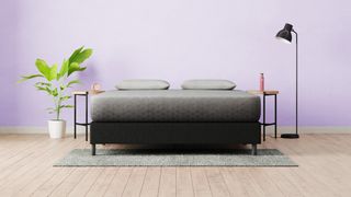 The Zoma Memory Foam Mattress in a purple bedroom with a wooden floor