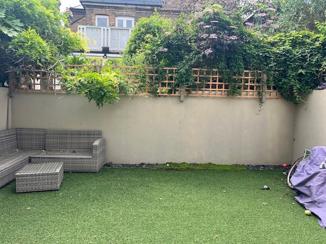 a modern garden filled with plants with a large checkerboard floor