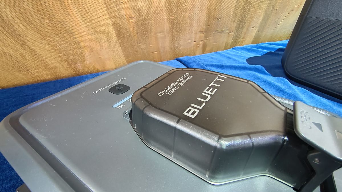 A Bluetti Transfer Hub on display on a table with a blue tablecloth