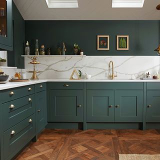 small dark green kitchen with marble worktop and splashback by Life Kitchens