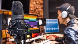 Condenser microphone with recording studio in the background