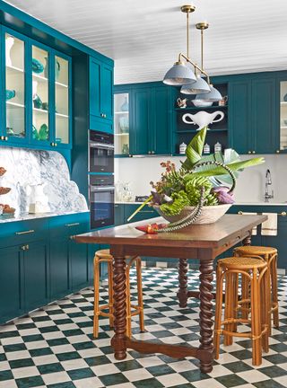 Blue and white kitchen with checkboard floor tiles and painted cabinets