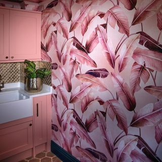 bathroom with pink wallpaper and sink
