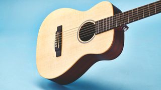 Acoustic guitar on a sky blue background