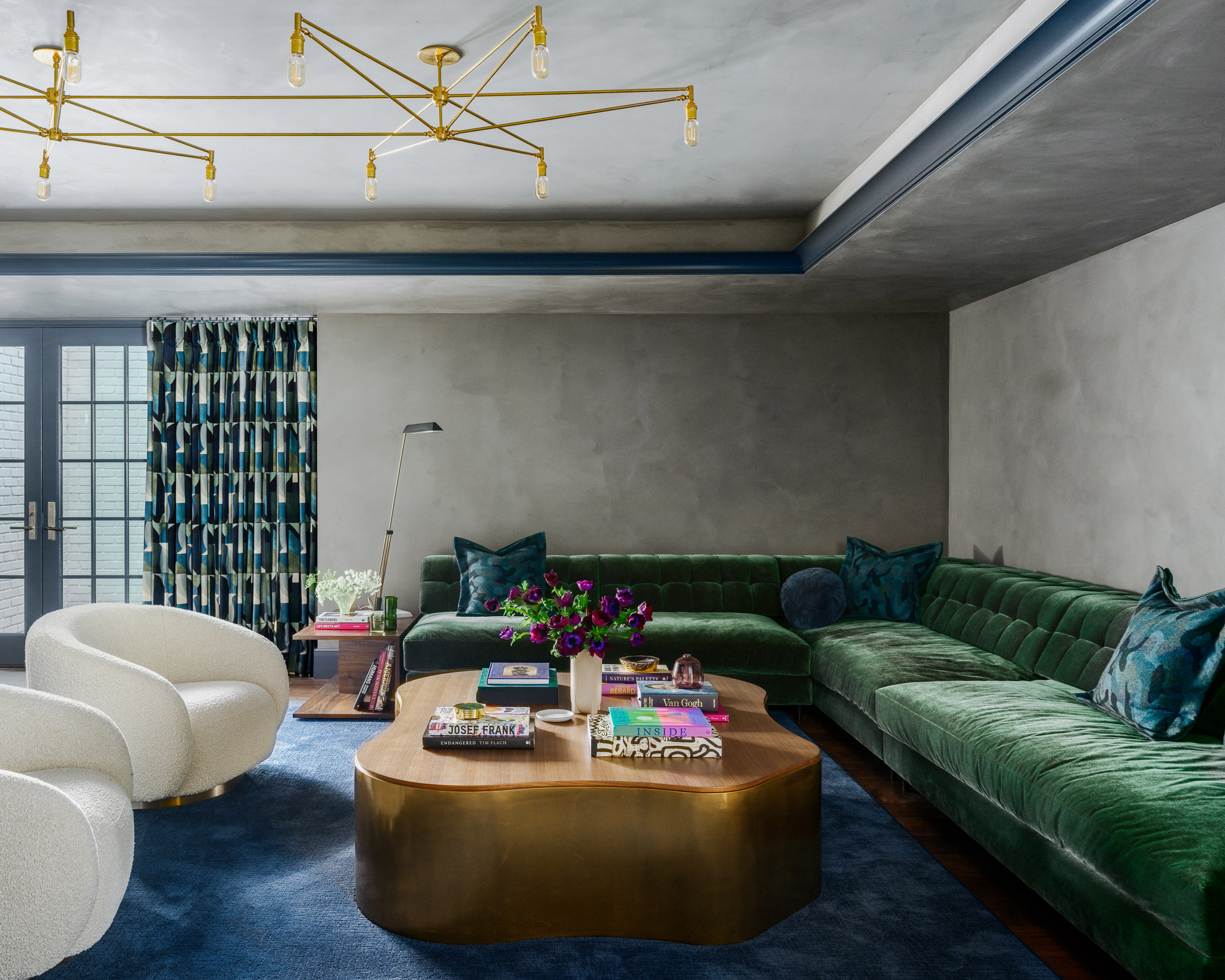 living room with green sofa and low furniture and large ceiling light