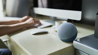 A Google Home smart speaker on a desk