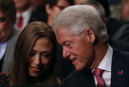 Bill and Chelsea Clinton chat during a presidential debate
