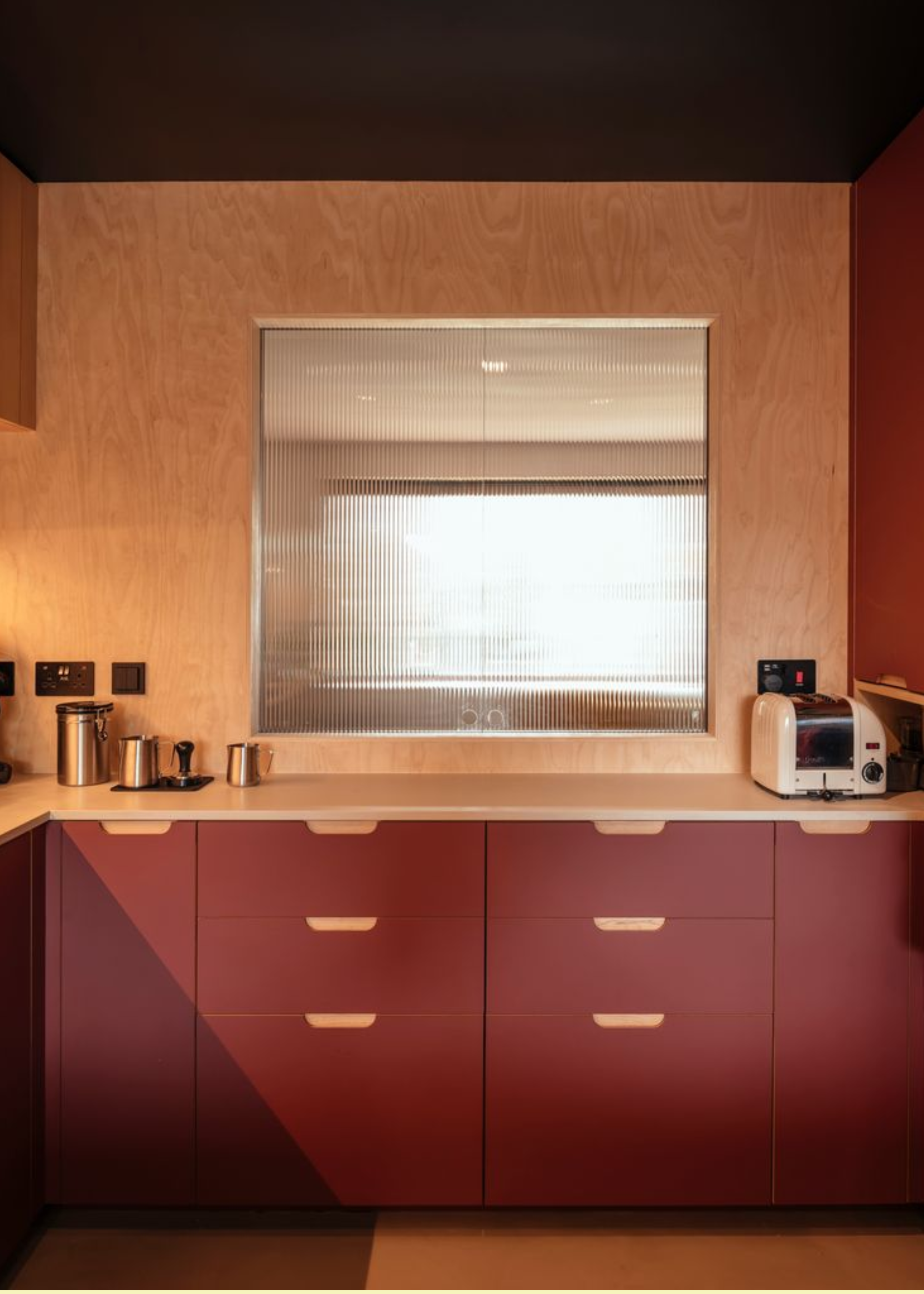 burgundy kitchen with wooden counters and walls