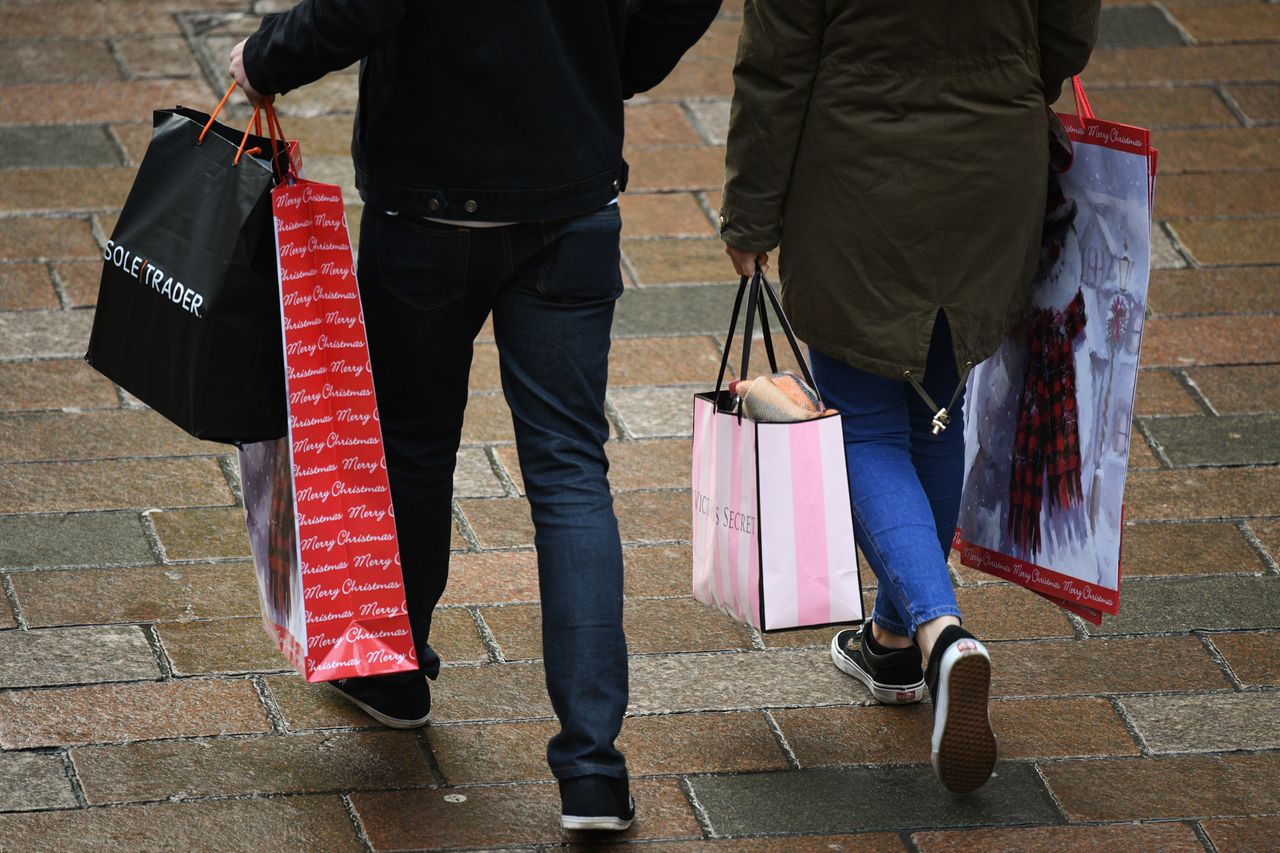 People carrying shopping bags.