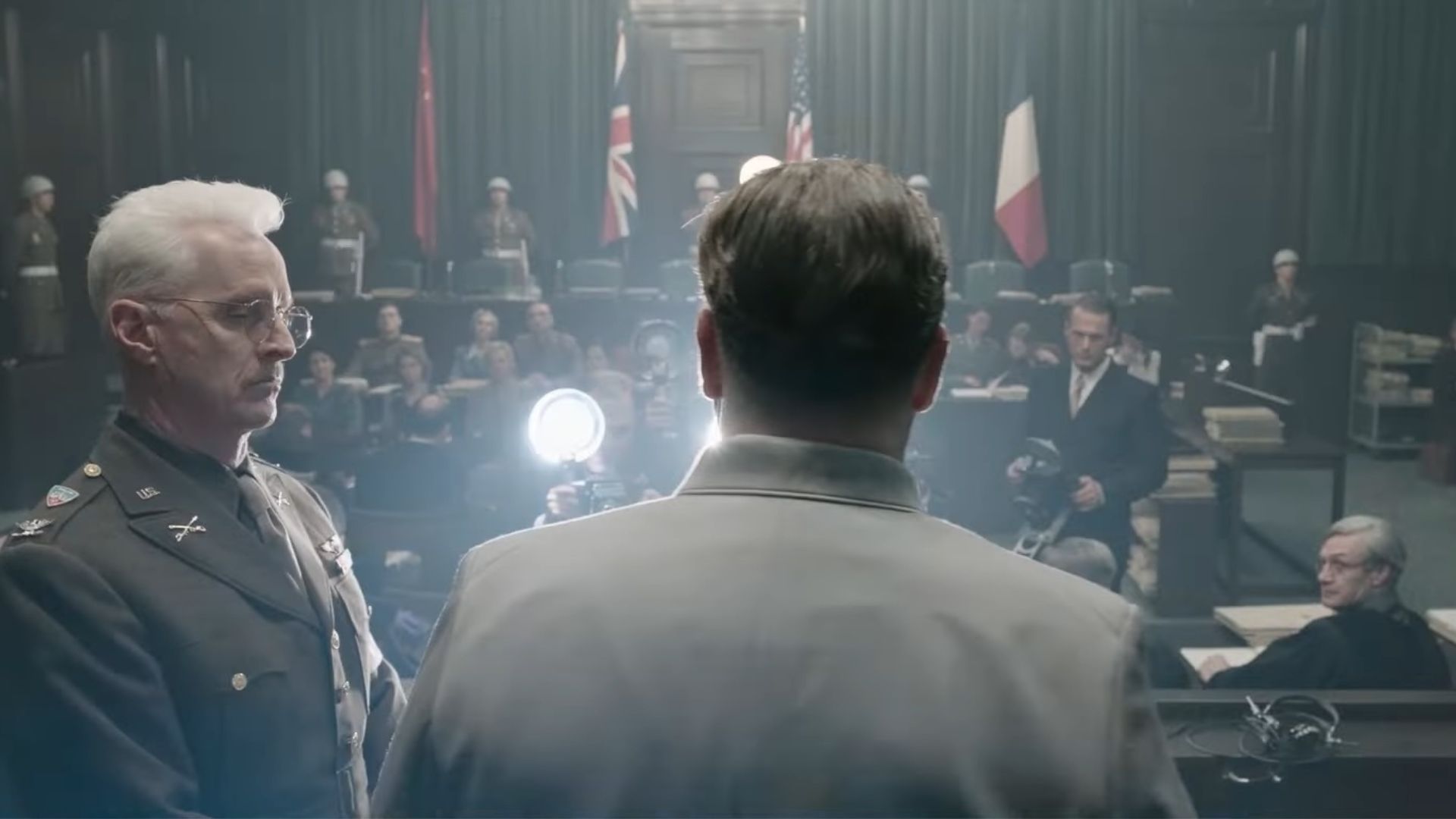A screenshot from the Nurnberg trailer showing a scene from the film recreating the trial 