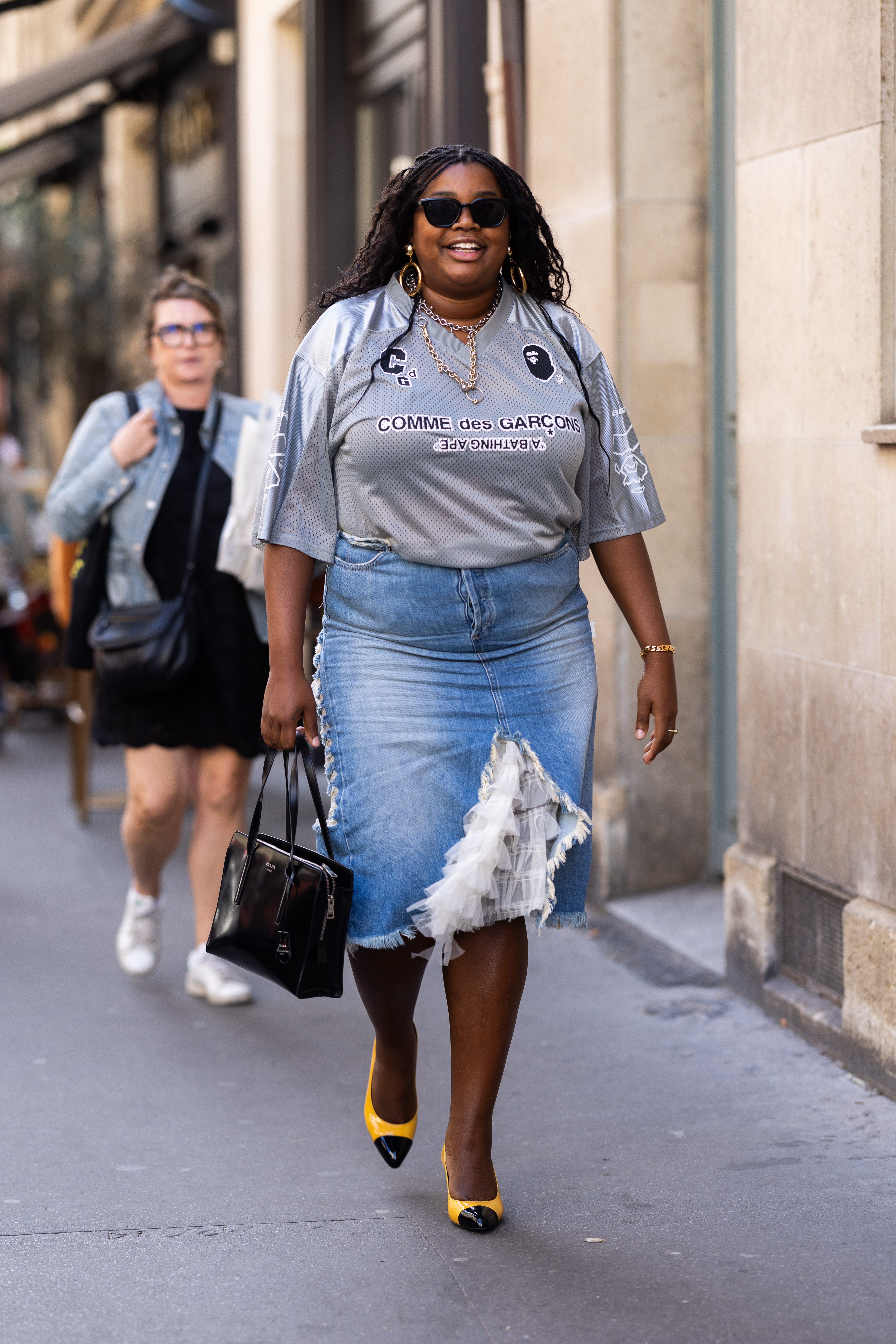 Woman wearing football shirt with midi denim skirt
