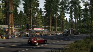 Cars pass in front of a roadside Bigfoot exhibit in American Truck Simulator