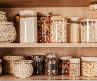 Glass jars of decanted food in a line on a shelf