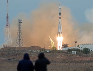 Spectactors watch as a Soyuz MS-02 rocket is launched with Expedition 49 Soyuz commander Sergey Ryzhikov of Roscosmos, flight engineer Shane Kimbrough of NASA, and flight engineer Andrey Borisenko of Roscosmos, Wednesday, Oct. 19, 2016 at the Baikonur Cos