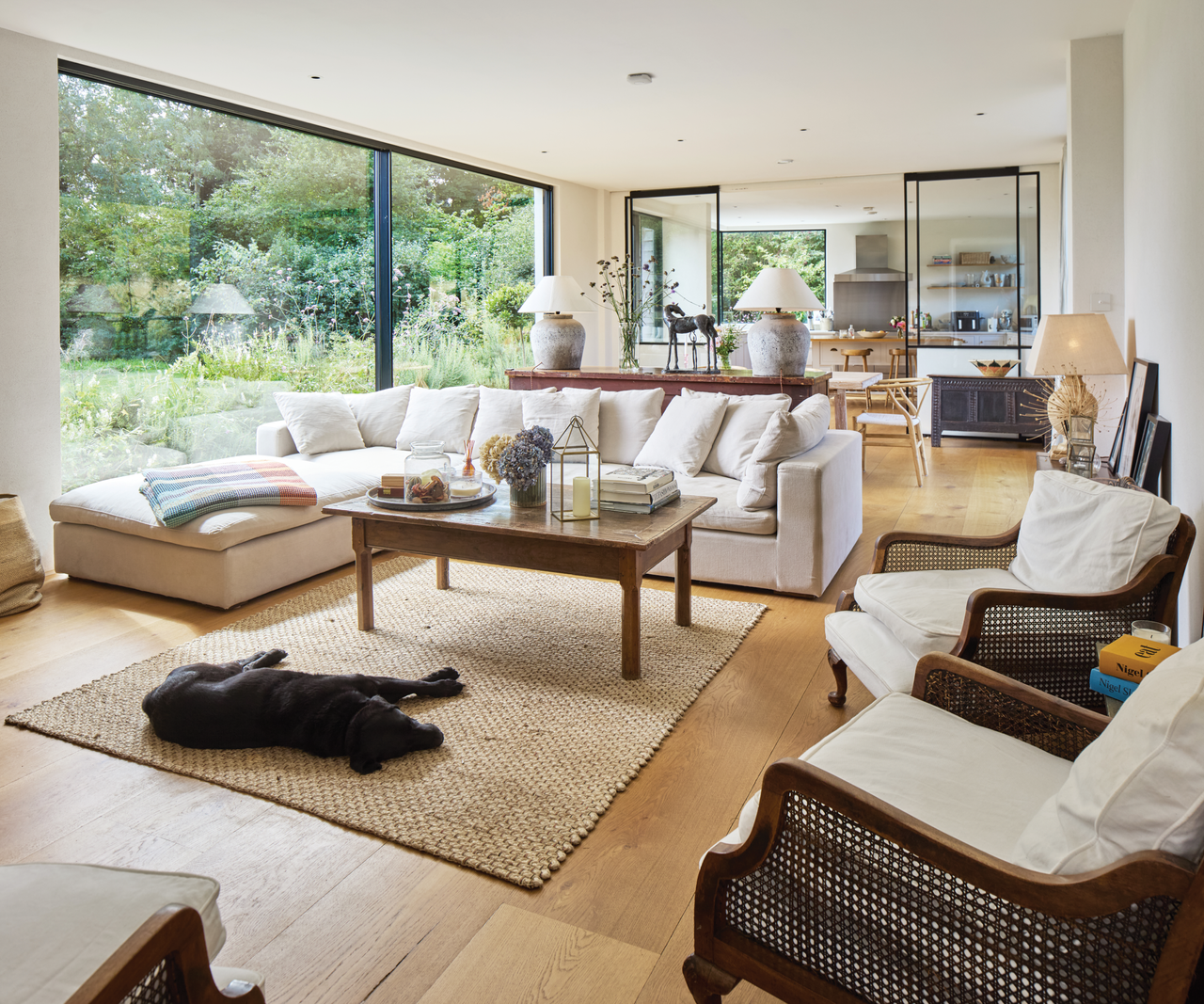 Living room with sliding doors to the left and kitchen behind sliding doors in the background