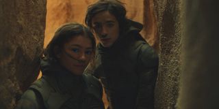 Dune zendaya and timothee chalamet as Chani and Paul walk in a cave