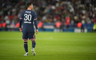 PSG forward Lionel Messi, standing, back to camera