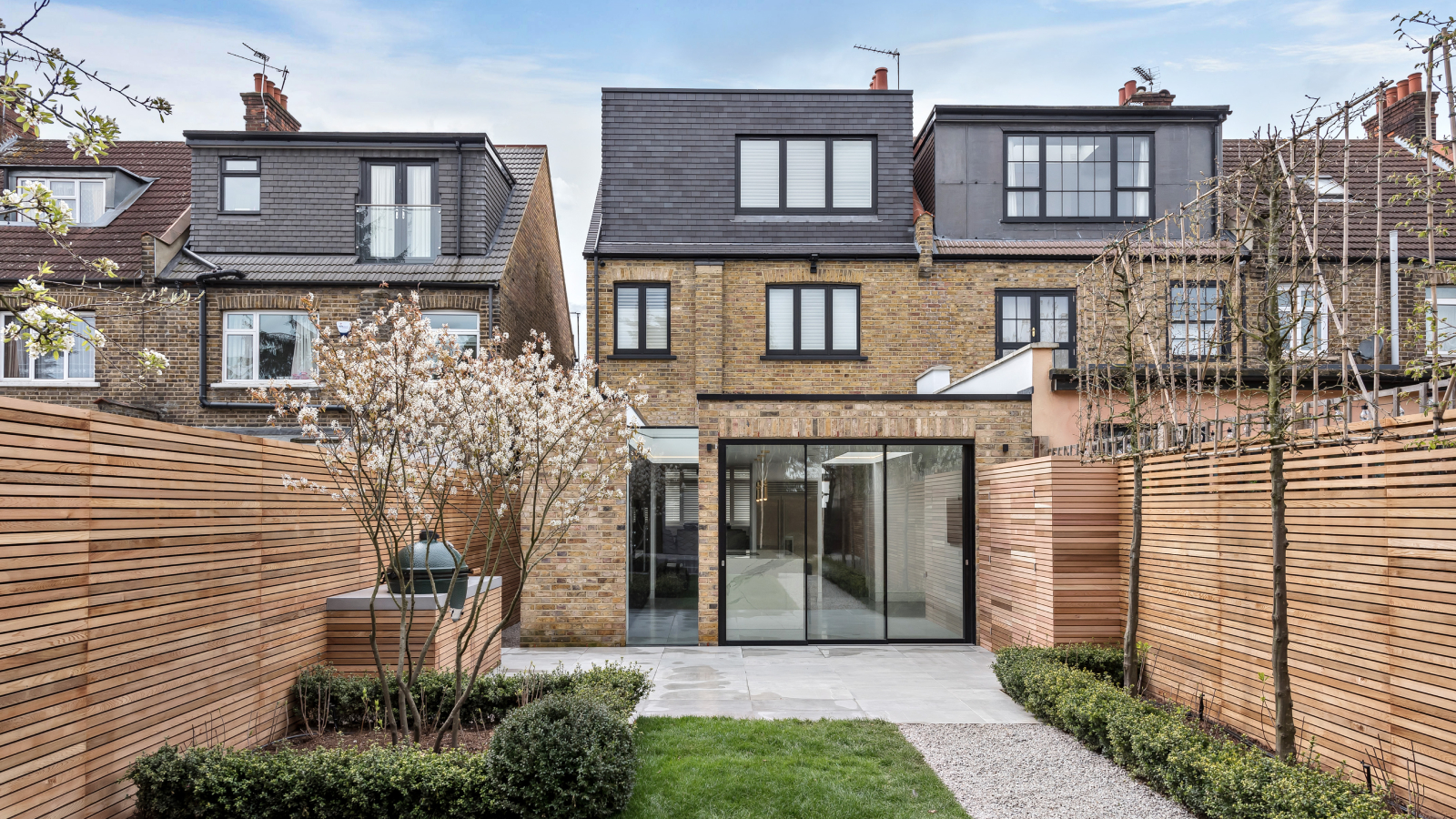 rear garden and exterior of house with single storey extension and loft conversion